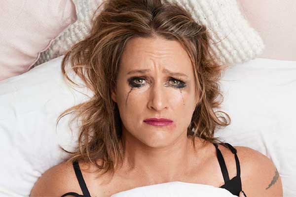 woman in bed crying