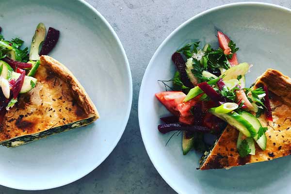 Quiche and salad on blue plate