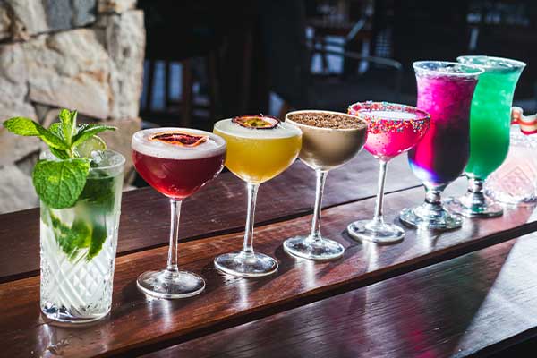 cocktails lined up on bar