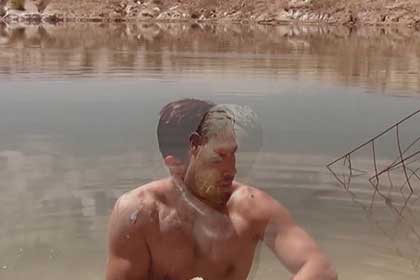 Photographic work showing a man sitting in a lake or dam Undercurrent Exhibition
