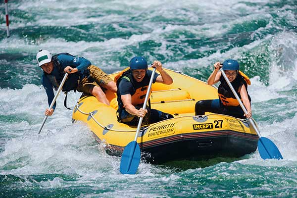 Destination NSW Three people in raft on Whitewater