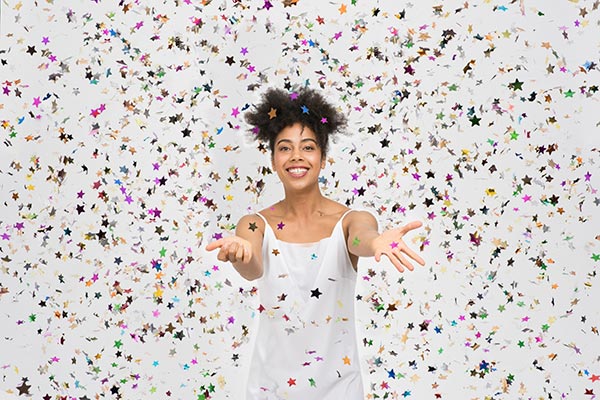 Smiling woman surrounded by glitter