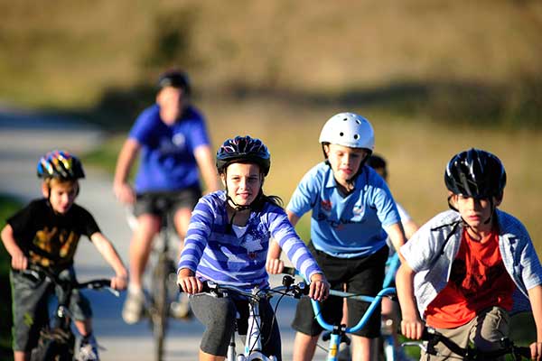 A group of children riding bicycles on a path