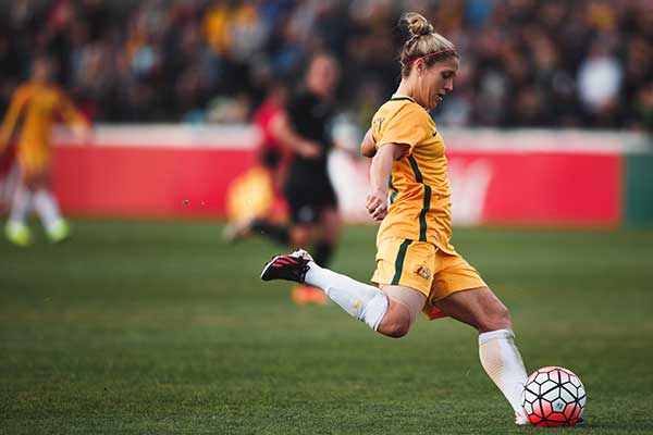 Matilda's player Katrina Gorry kicking a soccer ball during a match