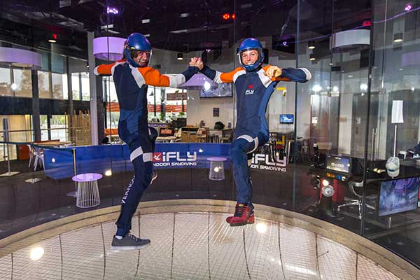 A man and woman holding hands whilst floating in the air