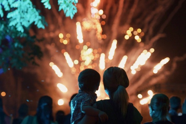 A mother and child watching fireworks dispay