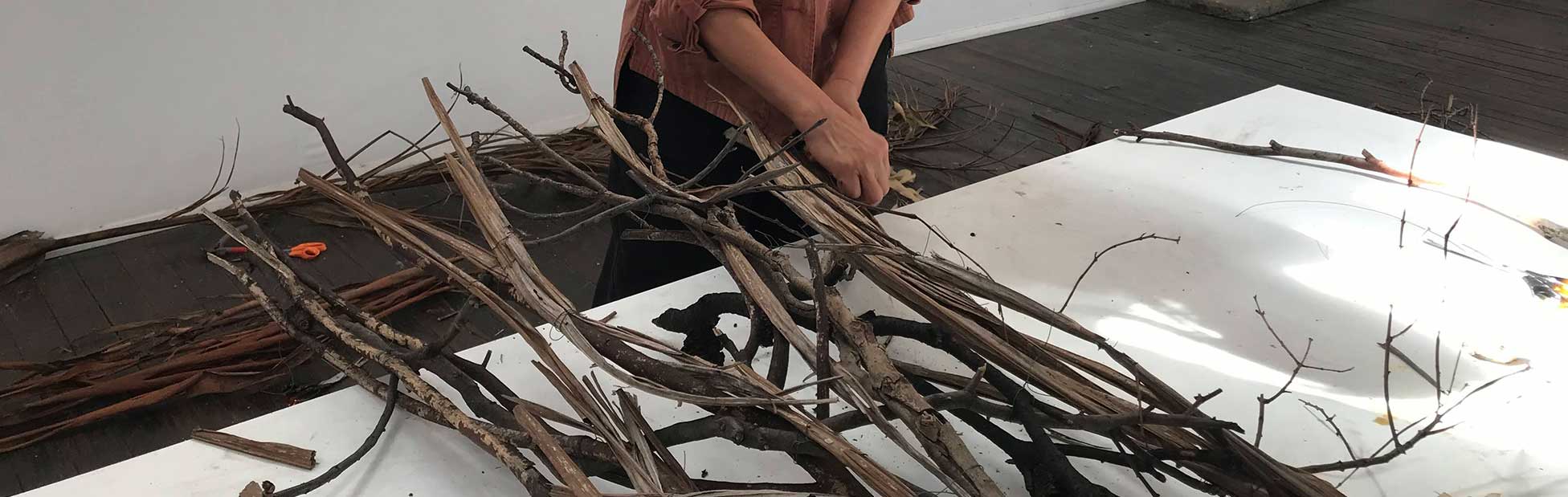 image of a lady with sticks