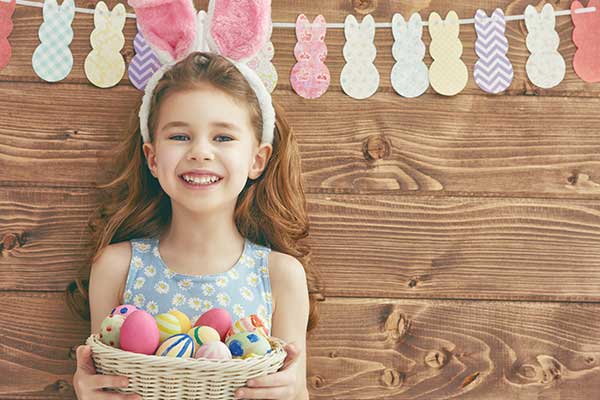 Girl smiling wearing Easter bunny ears
