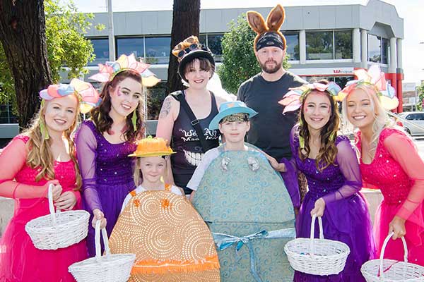A group of people in costumes enjoying an easter egg hunt