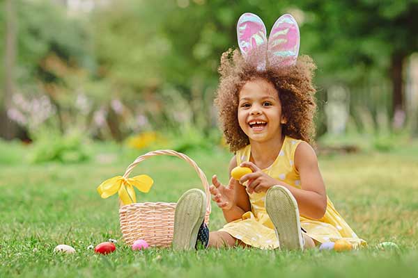 girl in garden with easter bunny ears