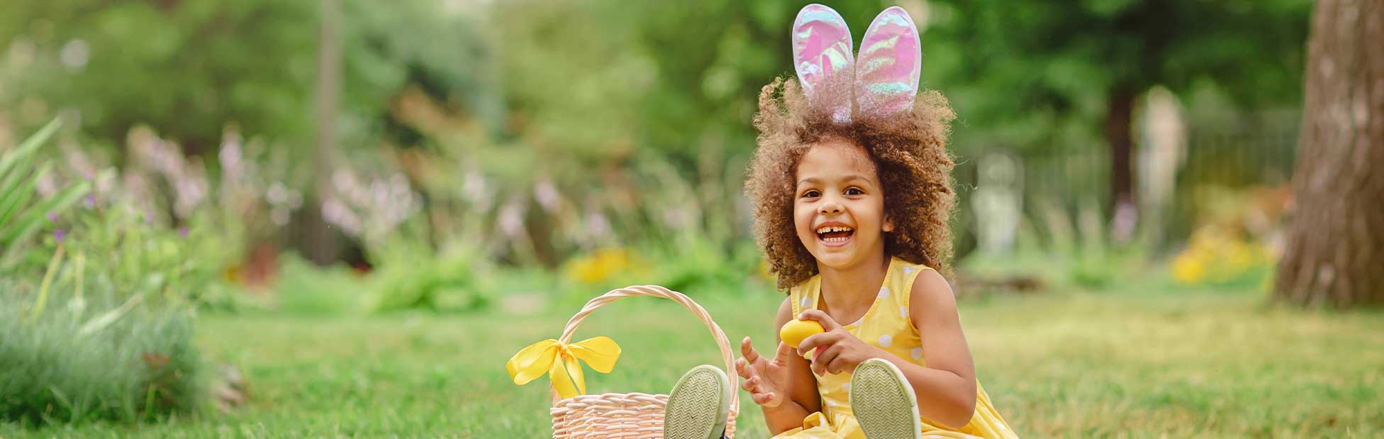 girl in garden with easter bunny ears