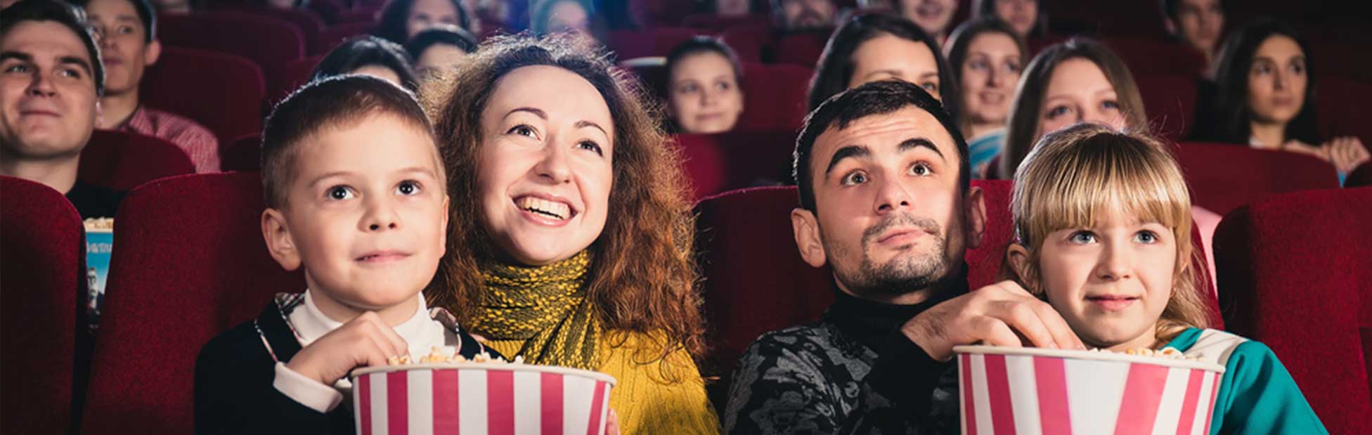 Family watching movie eating popcorn