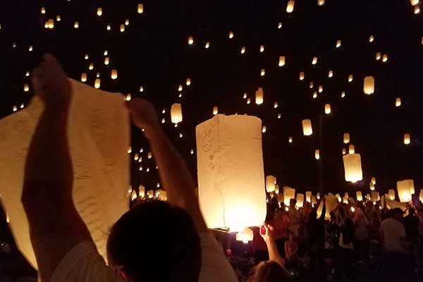 Crowd with lanterns in dark