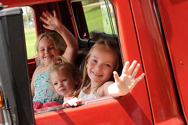 three girls in fire truck