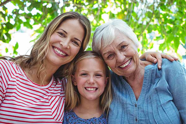 Girl, mum and grandmother smiling