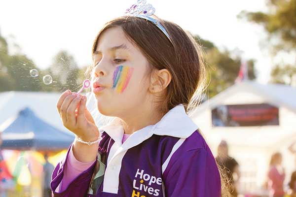 girl blowing bubbles