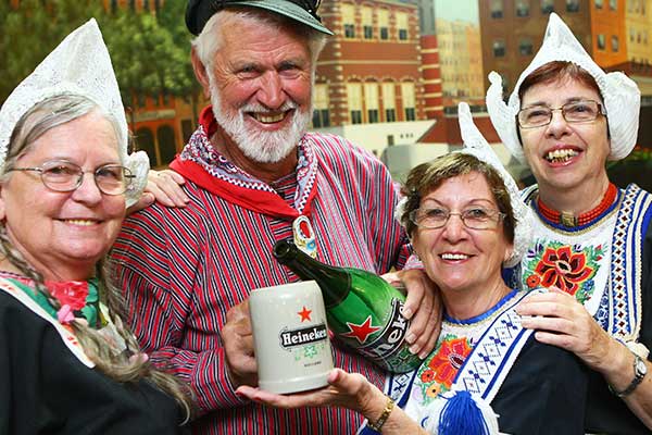 Three women and one man in full Dutch costume