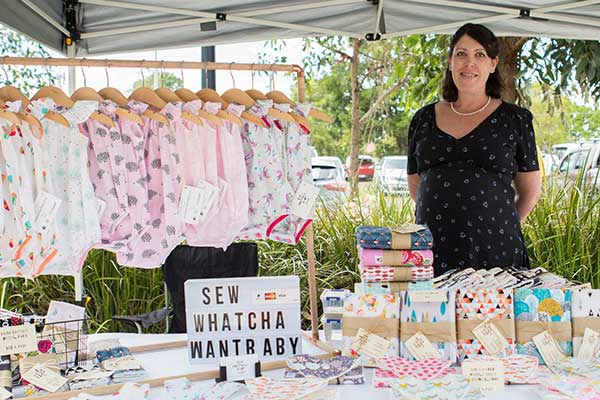 Woman stallholder selling baby clothing