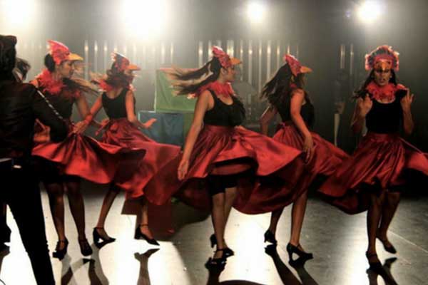 Women in large skirts spinning on stage