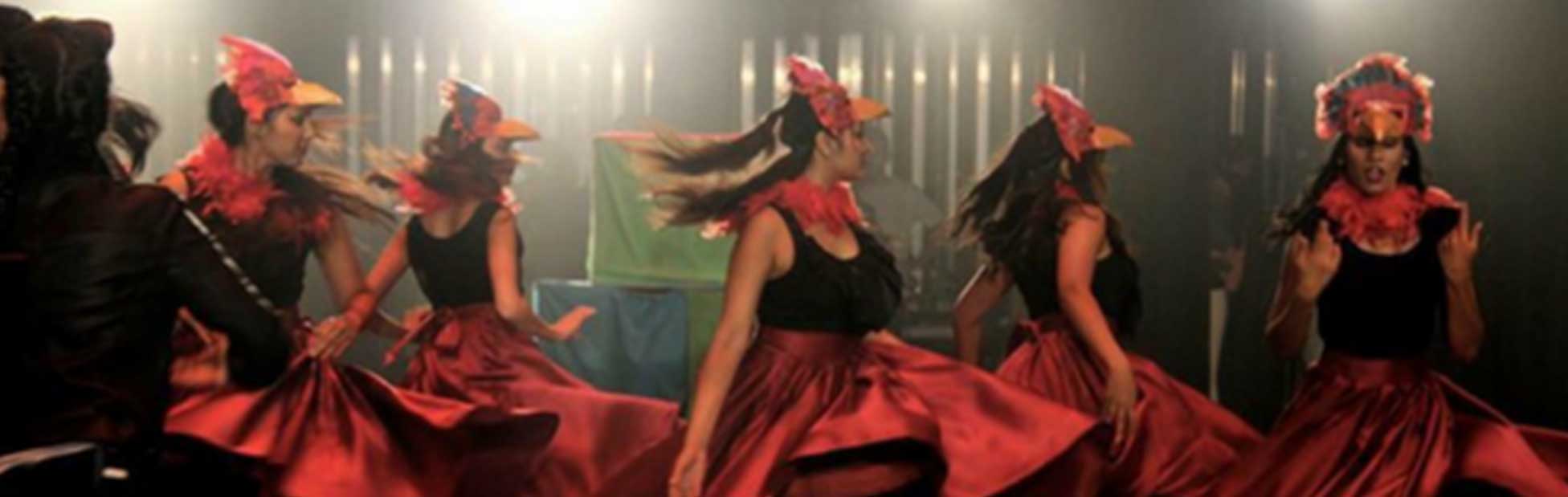 Women in large skirts spinning on stage