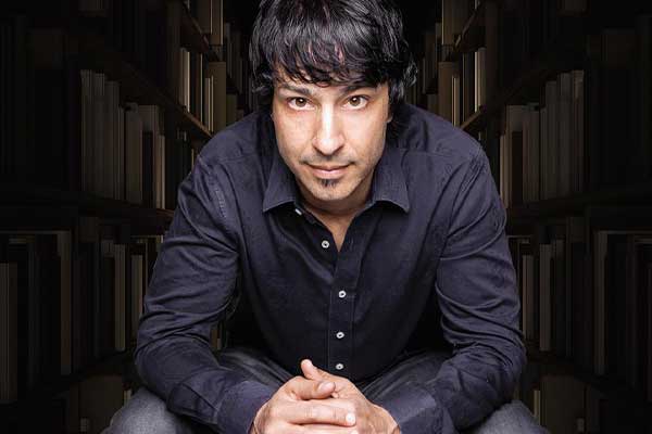 The Best of Arj Barker – Power Hour Arj Barker in black shirt leaning forward