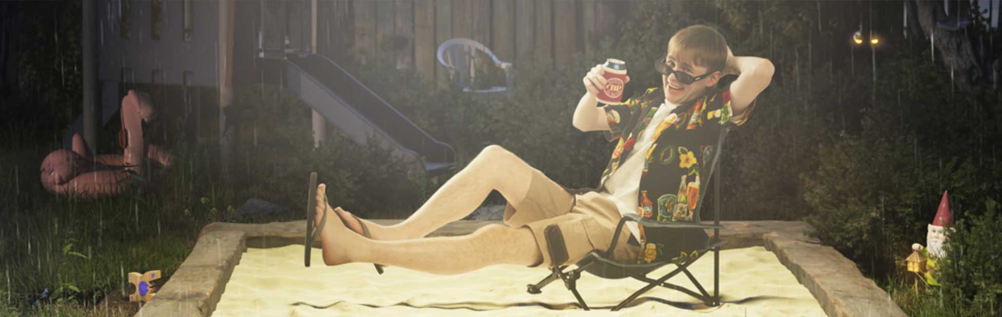 Blake Pavey drinking beer in deck chair in sandpit