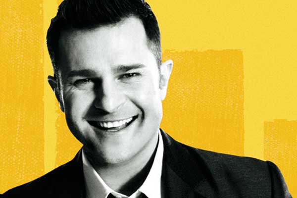 David Campbell smiling yellow background