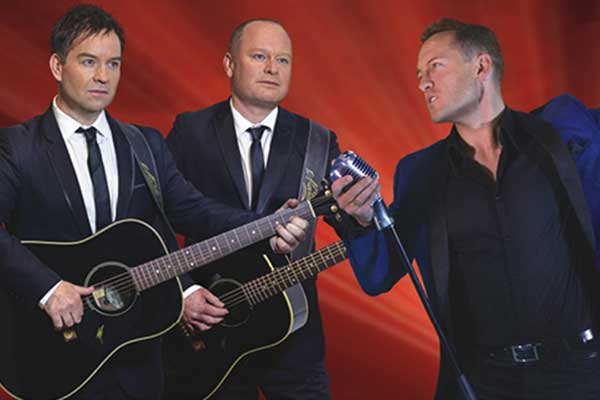 three men playing guitars