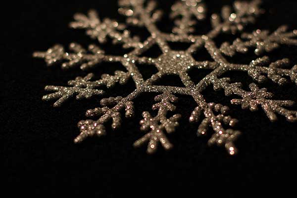 Christmas with Penrith Symphony Orchestra Sparking snowflake style cChristmas decoration on black background