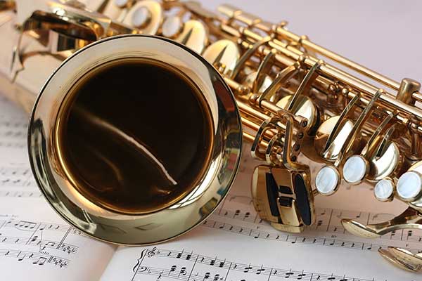 Saxophone placed on music sheet