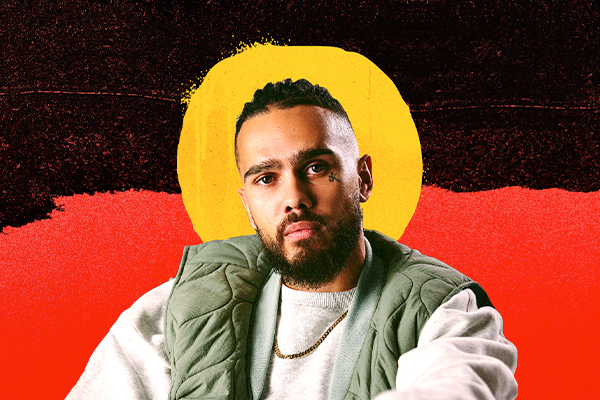 Performer in front of depiction of first nations flag