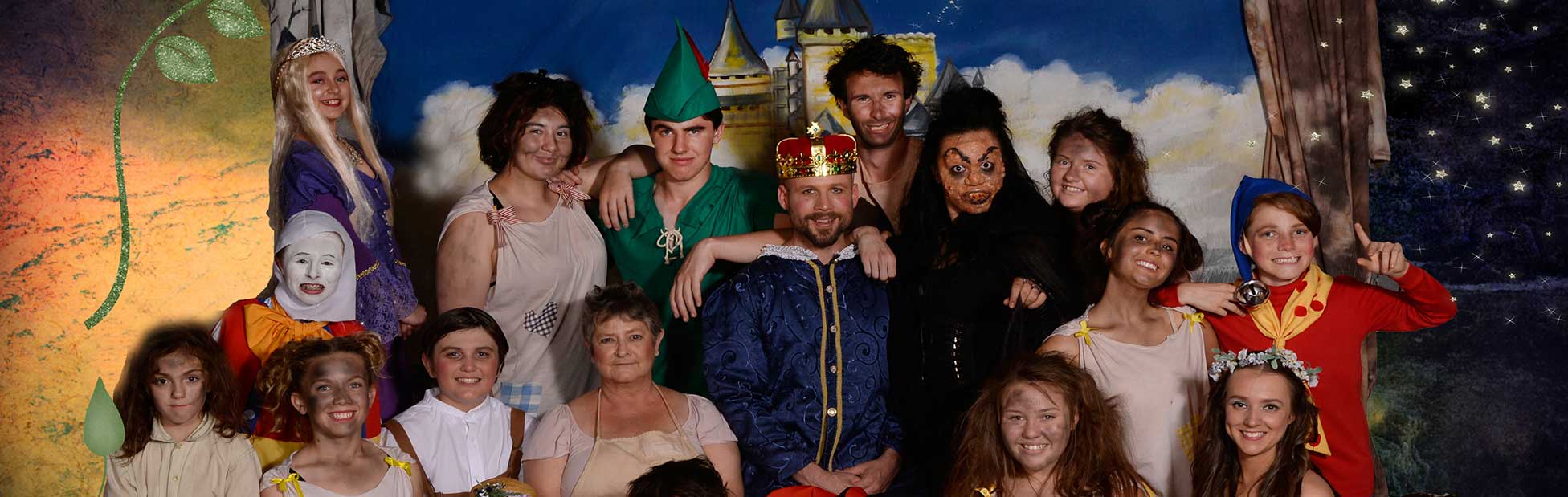 Cast of fairy tale in full dress posing for photo