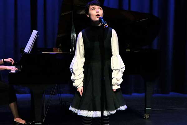 Penrith Con Annual Concert performer on stage singing