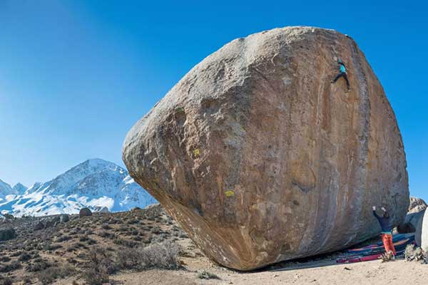 Huge rock with person pushing against it