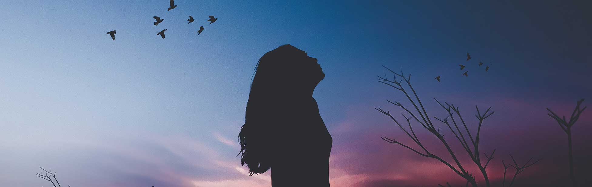 Woman silhouetted against sky
