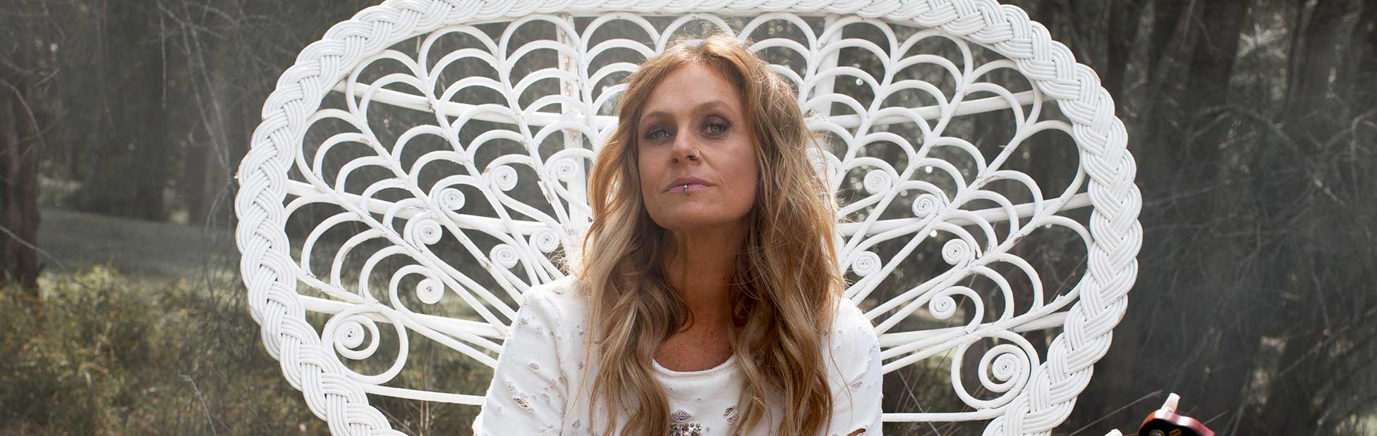 Kasey Chambers sitting in large white chair
