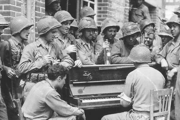 Military men around piano