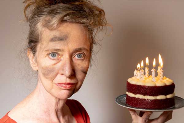singed woman holding cake with candles