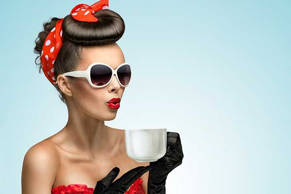 Woman wearing formal make up holding tea cup