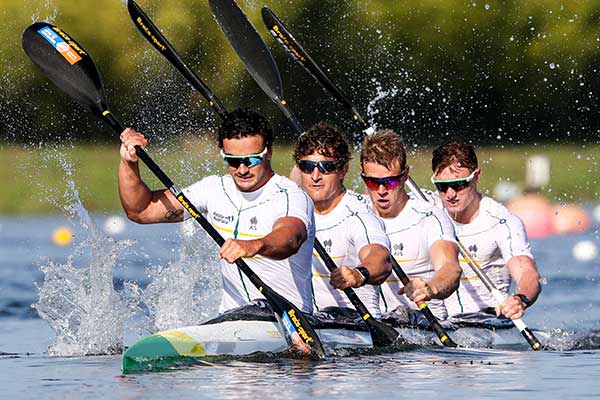 Four male competitors in canoe on water