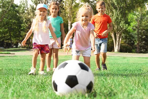 kids chasing soccer ball