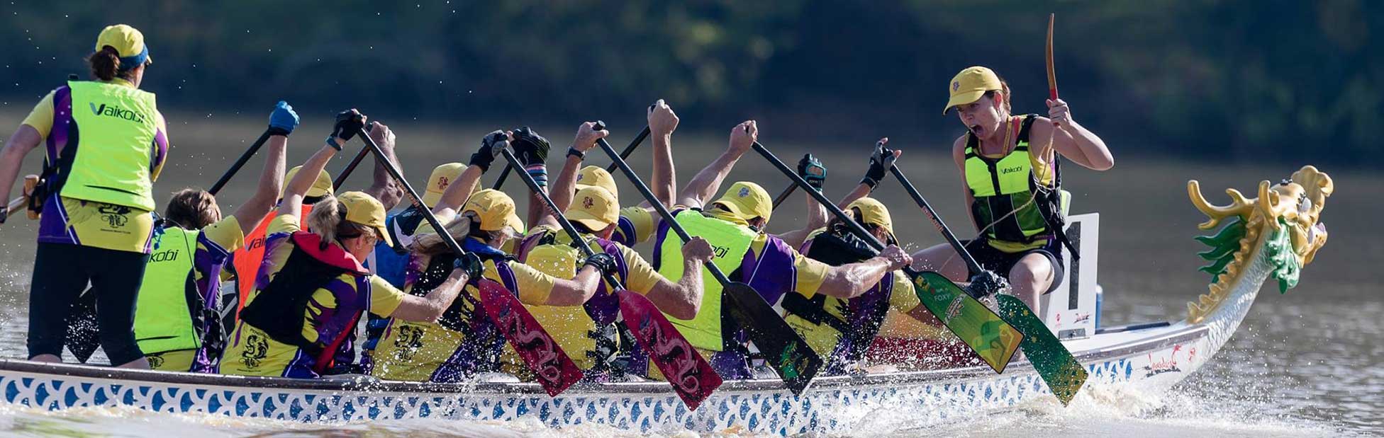 Full dragonboat with leader shouting