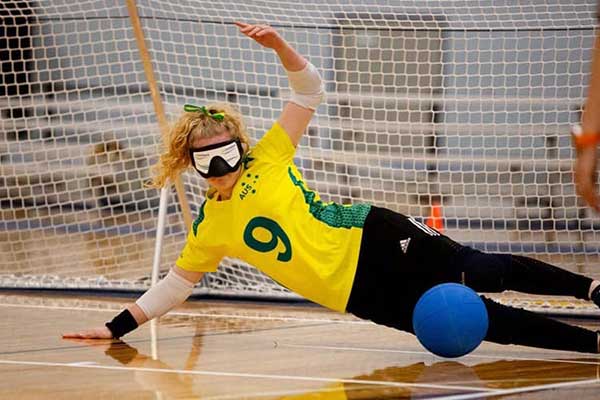 Woman in defending the goal wearing blindfold
