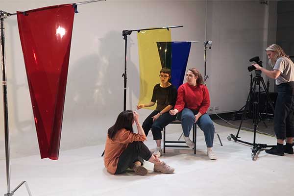 photographer and 3 people in studio space