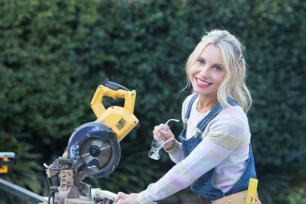 Cherie Barber posing for image in front of a saw