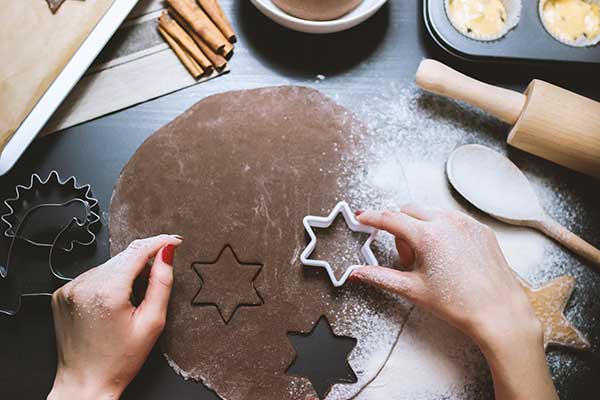 Woman's hand cutting star shaped cookies