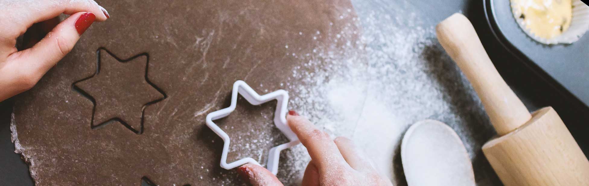 Woman's hand cutting star shaped cookies