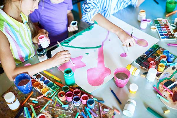 Child doing craft on messy table