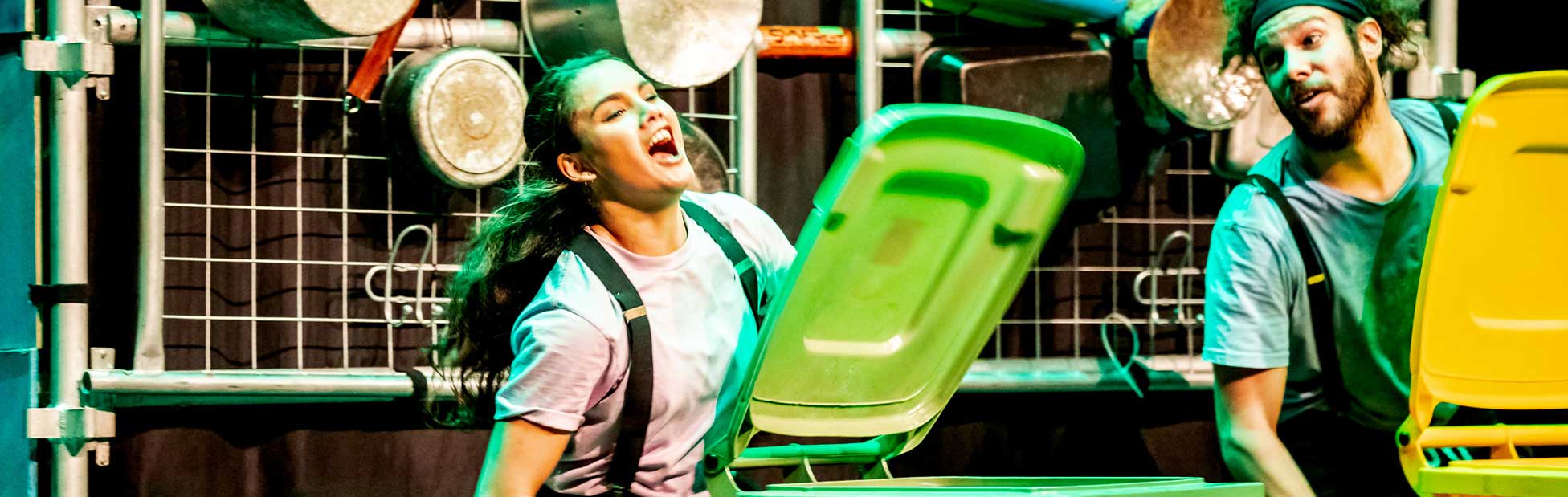 woman playing green bin like drum