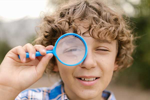 The Unsolved Mystery kid with magnifying glass